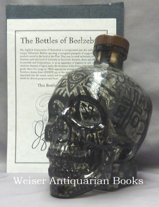 Item #68541 A skull shaped glass vodka bottle, heavily decorated with diabolic sigils and...