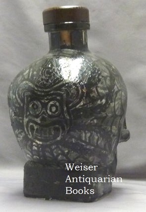 A skull shaped glass vodka bottle, heavily decorated with diabolic sigils and symbois by artist Barry William Hale. One of only 7 "Bottles of Beelzebub" that he produced thus, each obviously unique.